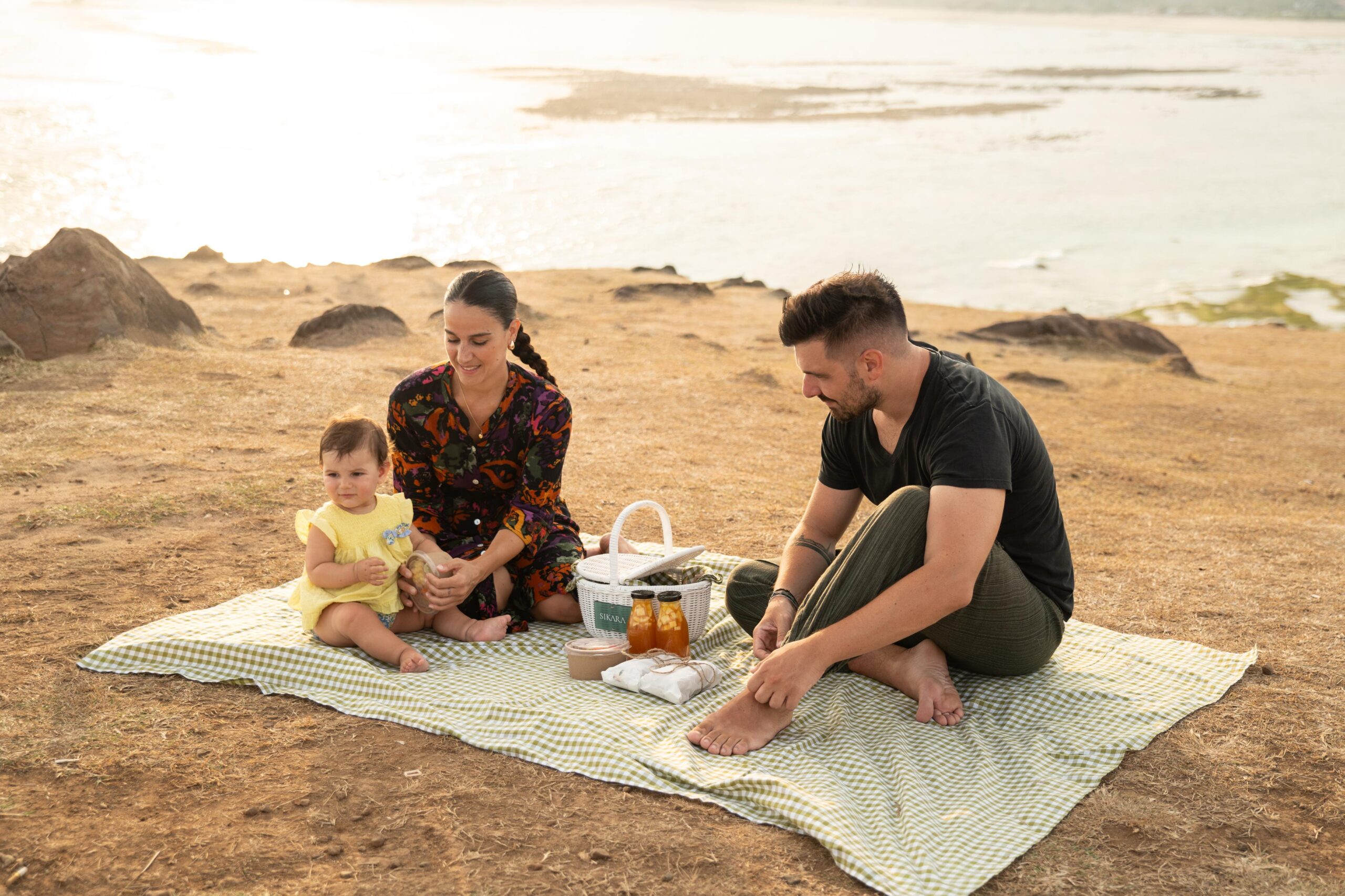 couple with son taking a picnic at the beach